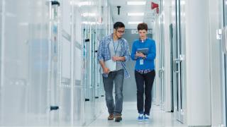 Man and woman walking in server room